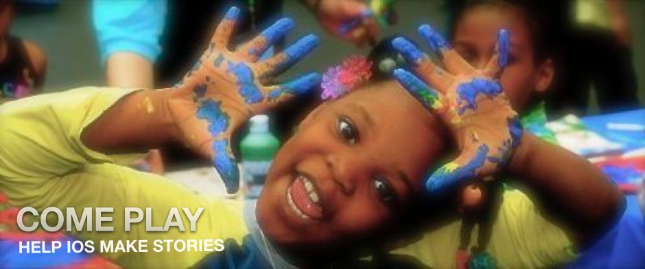 Be Involved_Volunteer_Photo of African American toddler with finger paint on her waving hands